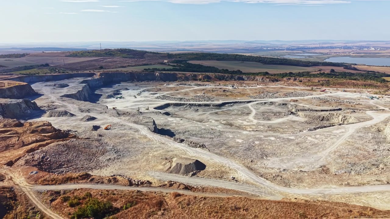 Granite quarry located in a rural area, showing vast extraction site and surrounding land
