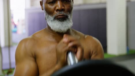 Senior-man-exercising-with-barbell-weight-4k