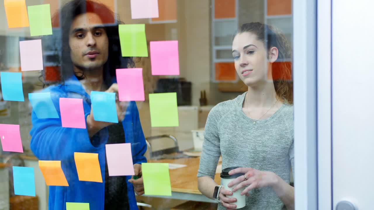 Executives discussing over sticky notes