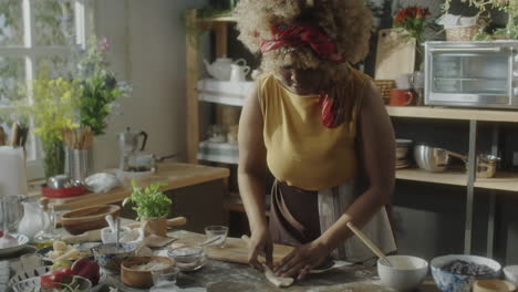 woman baking and preparing food in a rustic kitchen