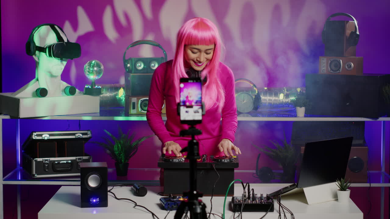 Female DJ performing with turntables in a studio with neon lights