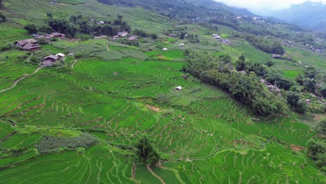 semi orbit drone footage of terraced landscape and village homes at golden hour in sa pa vietnam