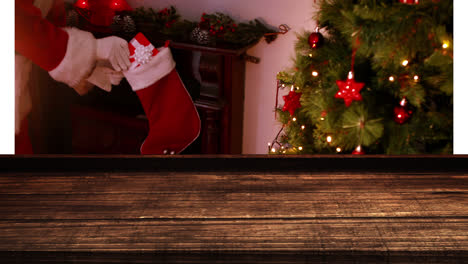 wooden foreground with christmas background of santa bringing gifts to stocking