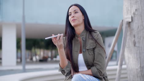 young woman using her smartphone in town