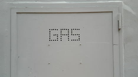 close up of a metal door with gas sign on it