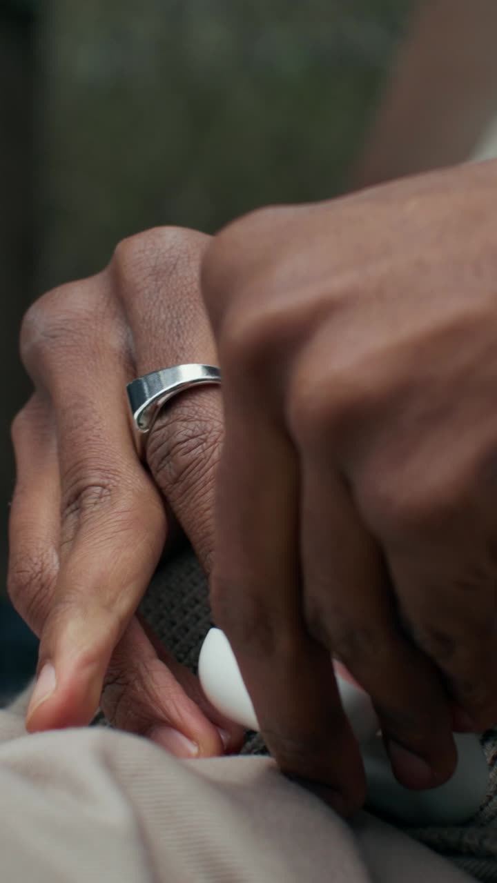 Hands with Ring and Earbuds