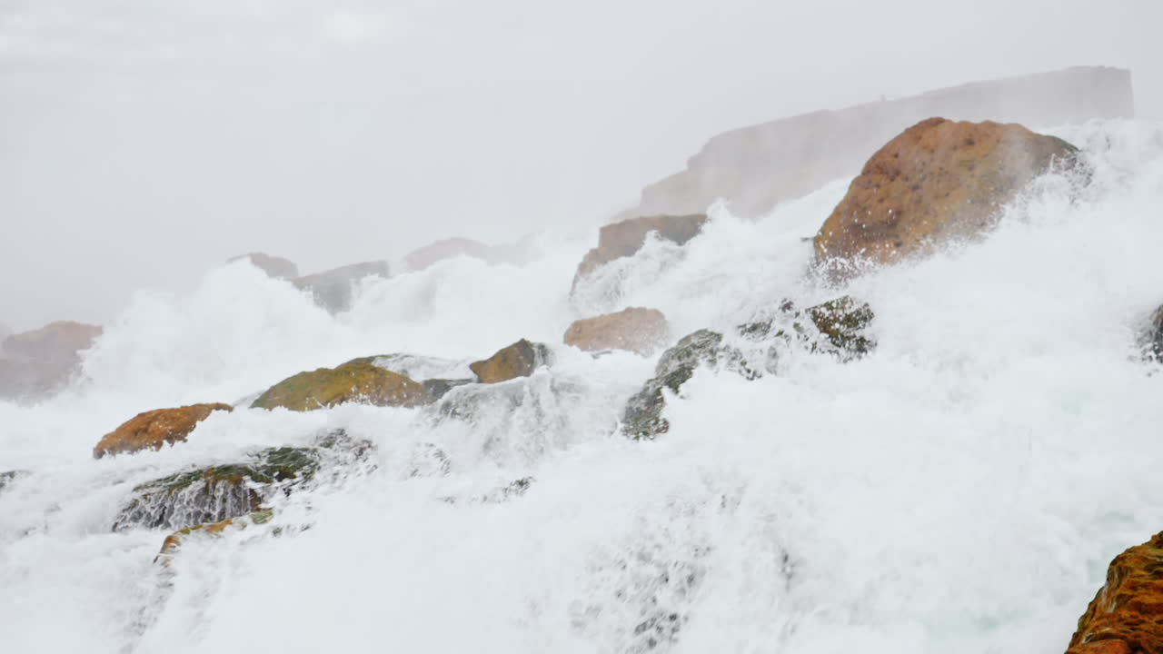 Foaming Water Crashing On Rocks