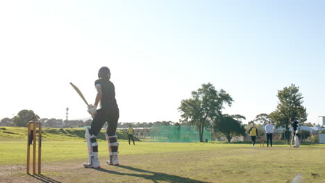 two teams of multiracial male cricket players and male umpire playing cricket on pitch