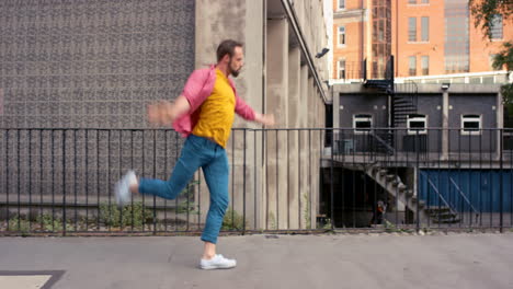 a young man dancing against an urban background