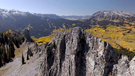 drone flys down rock spine on ruby peak looking at marcellina mountain and anthracite range colorado