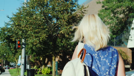 woman using crosswalk while on phone