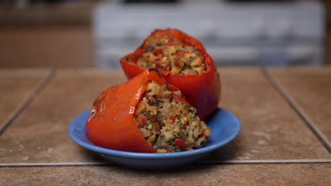 stuffed sweet bell peppers on a plate and ready for that first mouthwatering bite - slow dolly forward