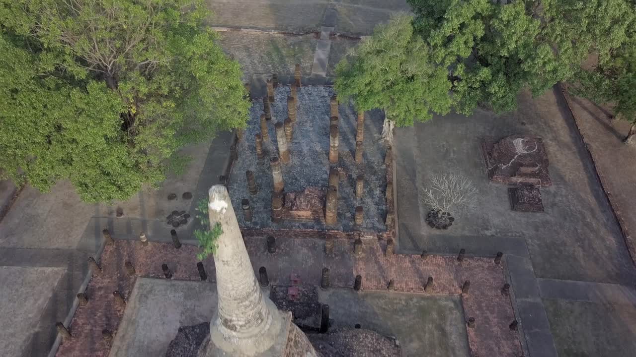 Aerial backwards and over Wat Chang Lom at Si Satchanalai Historical Park,Thailand.Descending and getting closer to the monument.