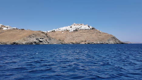 picturesque island town on a hillside overlooking the calm sea