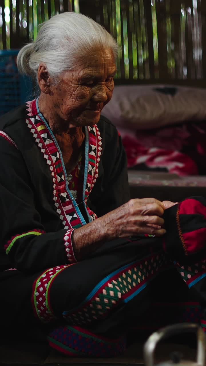 Elderly Woman Sewing Traditional Clothing