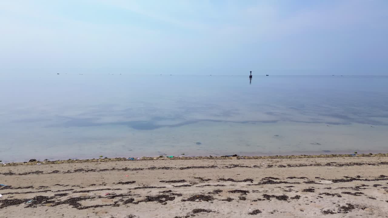 Stunning aerial drone footage of My Hoa Lagoon featuring a scenic lighthouse and tranquil waters in Vietnam, surrounded by lush nature and shallow water