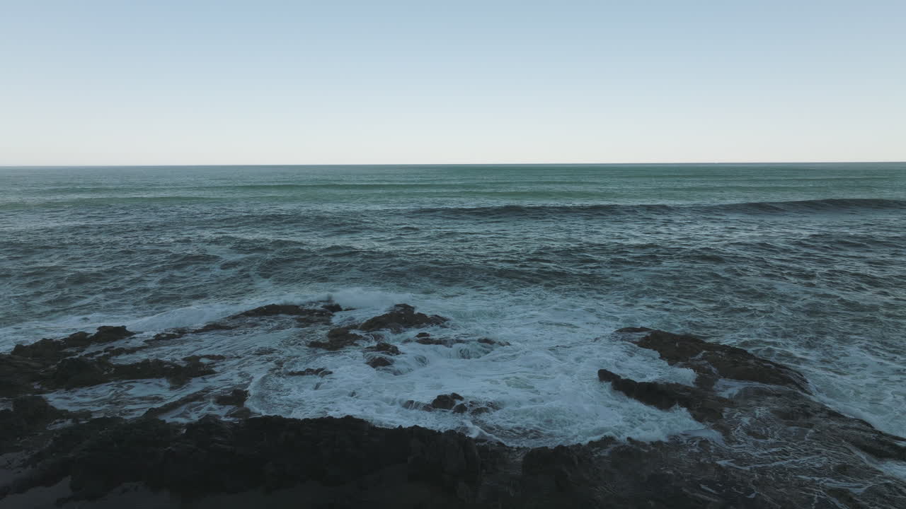 Aerial static of Thor's Well on the Oregon Coast, showcasing the wide expanse of Cape Perpetua's rocky shoreline