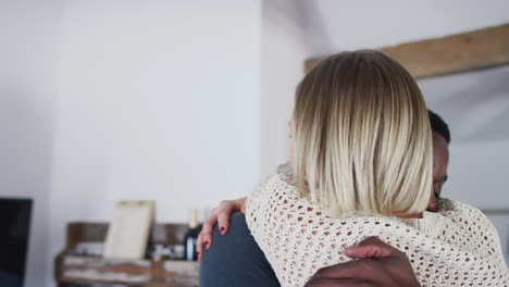 couple spending romantic weekend away hugging in hotel room