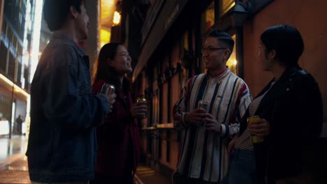 friends enjoying drinks in the city at night