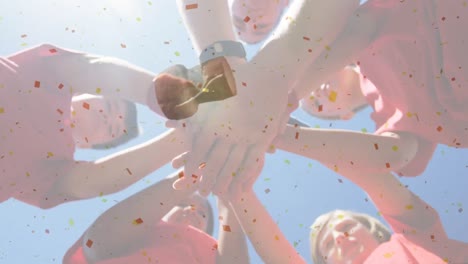 animation of confetti falling over team of diverse children clapping hands