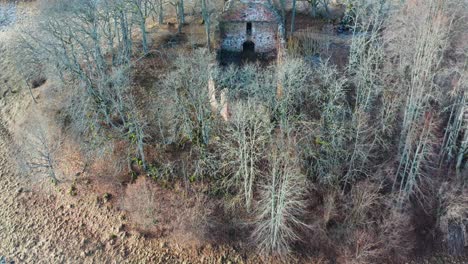 aerial view of countryside church bell tower and stone boulder wall remains