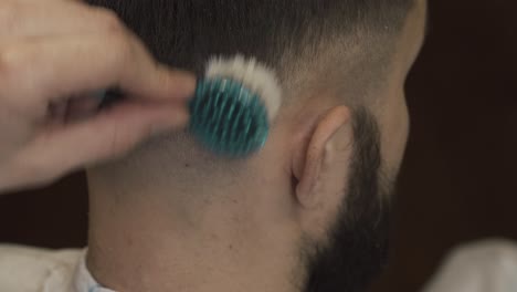 close-up of a barber giving a fade haircut with clippers