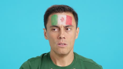 very nervous man supporting mexican team during a difficult match