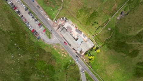 kirkstone pass busy road a592 traffic time lapse showing the kirkstone pass inn from above with sunlight sweeping across. top down view. summer. lake district, cumbria, uk