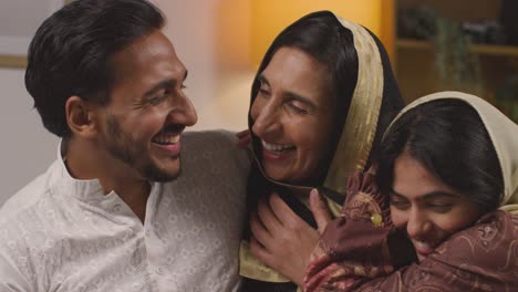 loving and happy muslim muslim family celebrating eid hugging each other at home