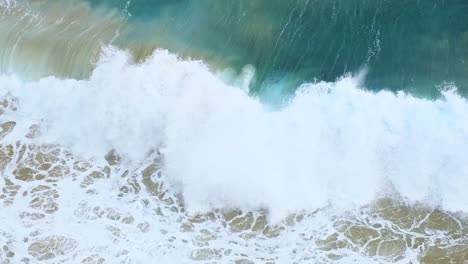 Swell-of-blue-and-emerald-color-Cantabrian-sea-hitting-the-beach-of-Isla-island