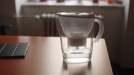 Water-filter-kettle-standing-on-desk-in-office