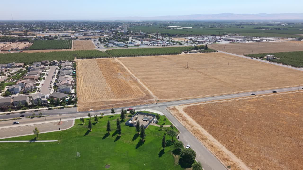 Aerial view of a town with fields and residential areas