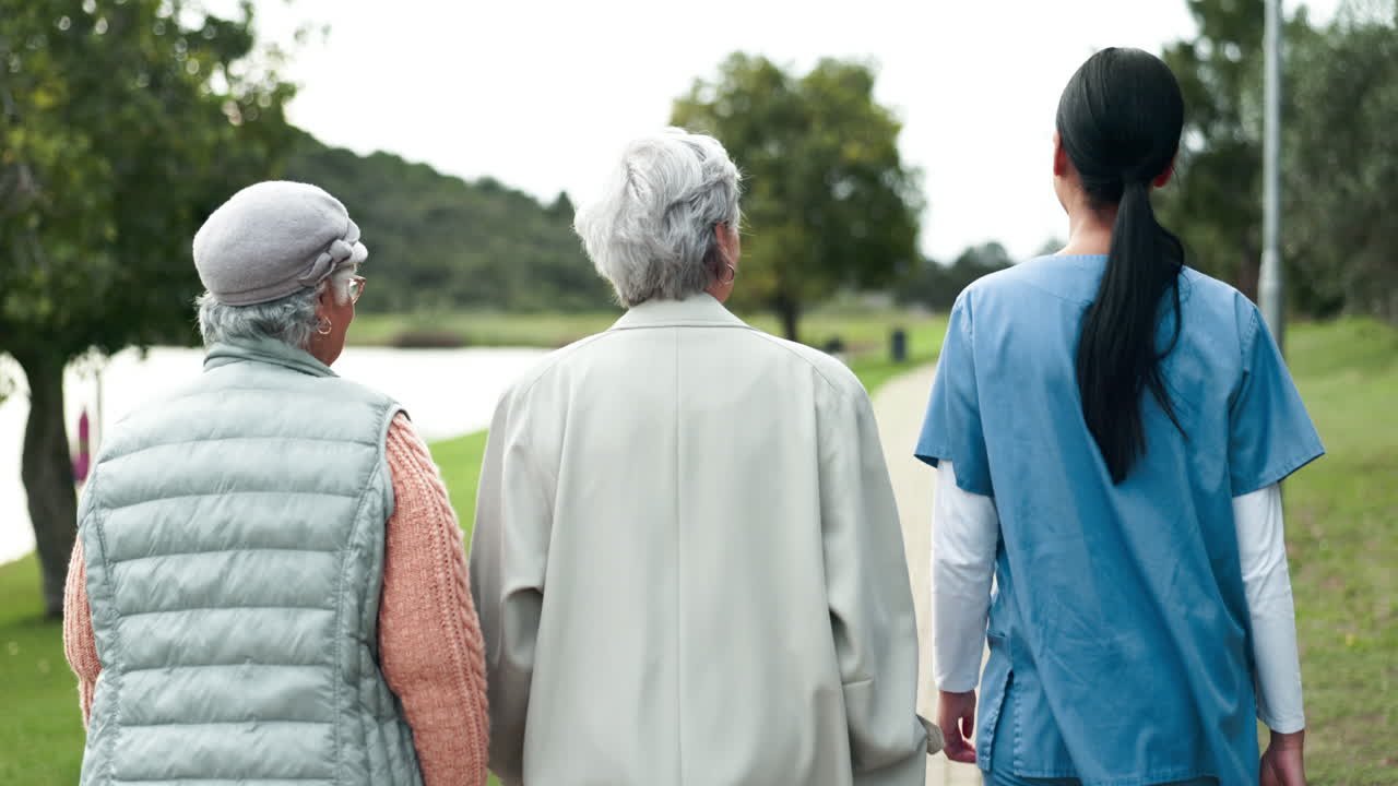 Senior women walking in the park with caretaker