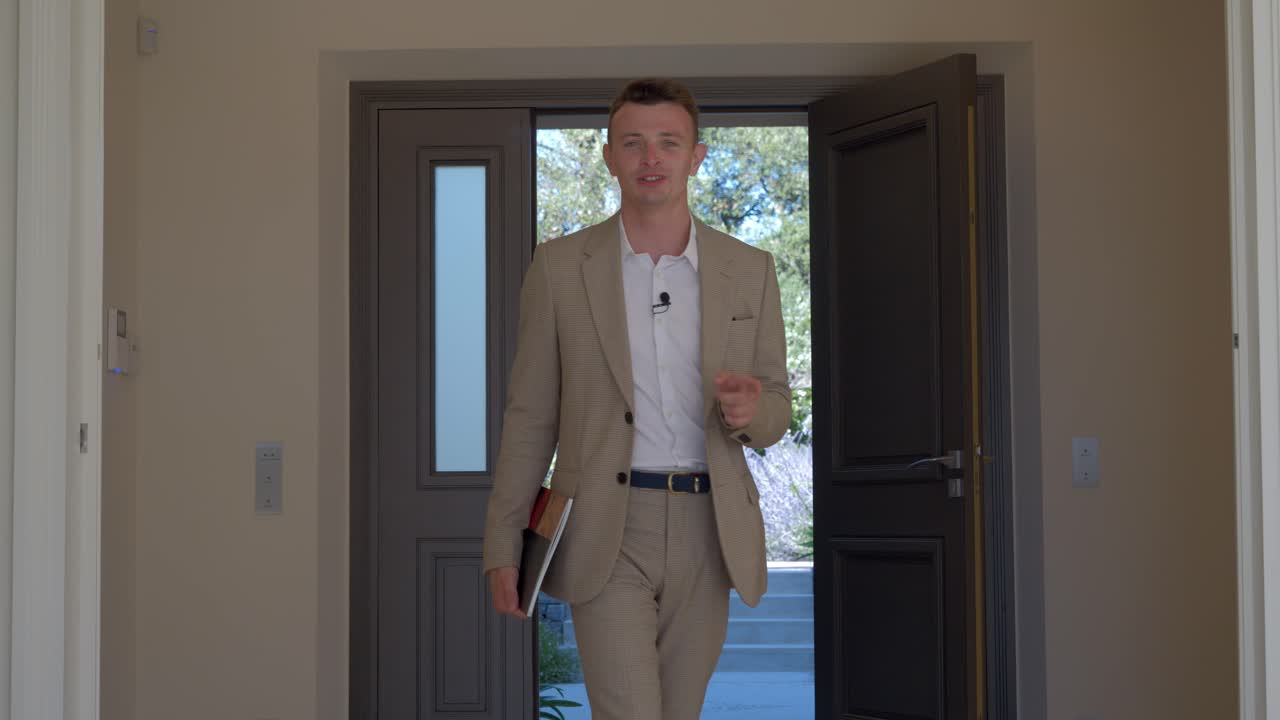 Real estate agent giving an enterence for the property that he's selling