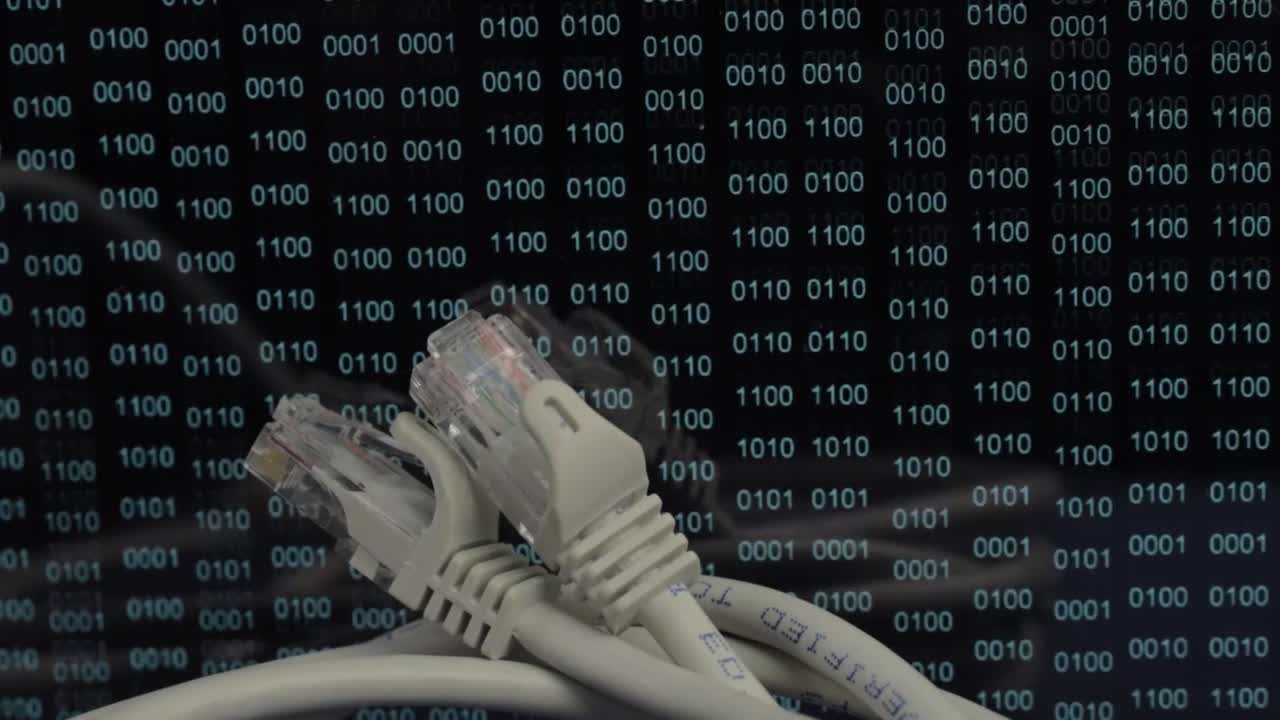 Ethernet network cables with green binary data output background