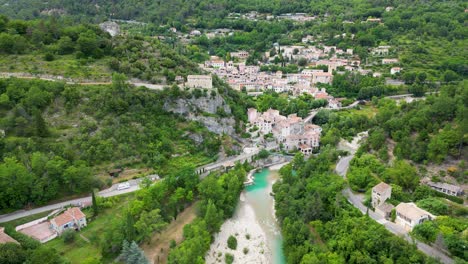 smooth drone footage showcasing a peaceful village in the hills, with vibrant summer landscapes all around.