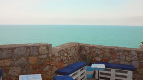 bench area on peniscola island with sea and horizon view at background in castellon, spain