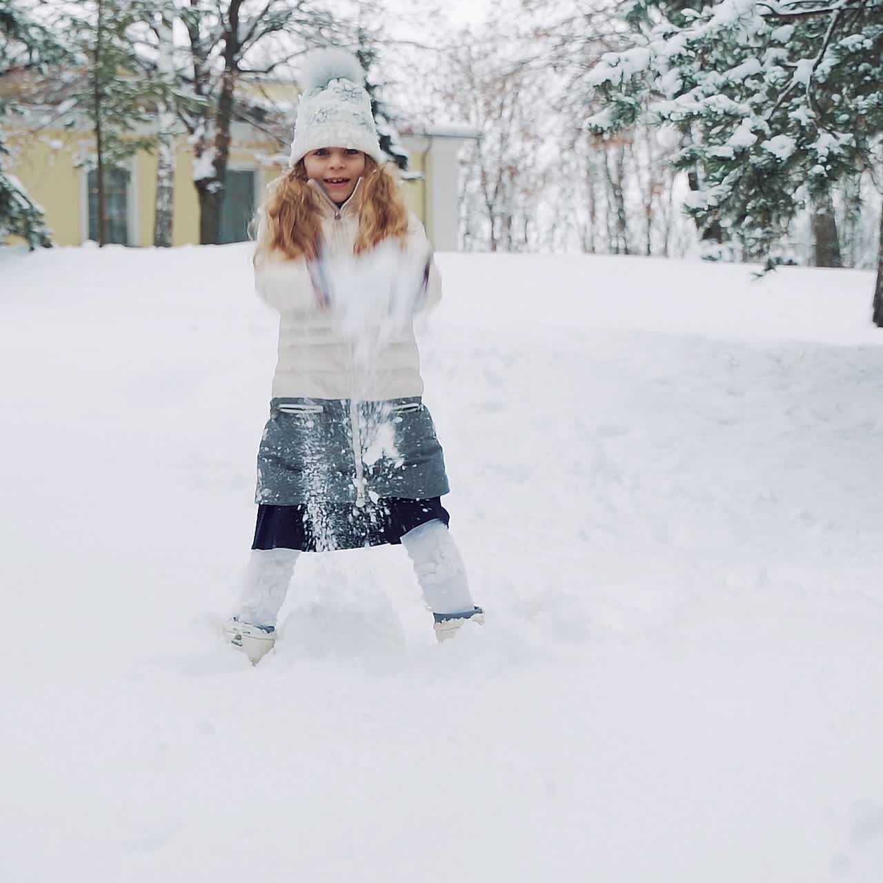 Happy girl playing in snow