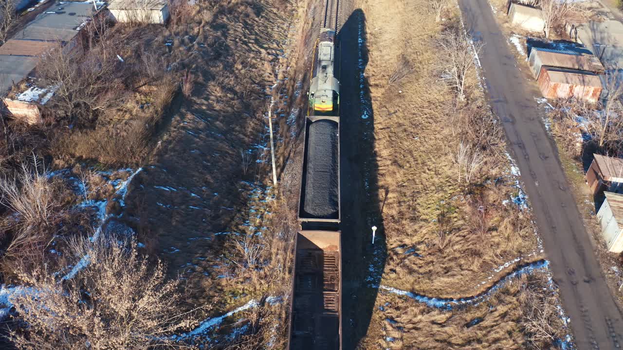 Train on railroad from above. Aerial view of train on railway track through countryside