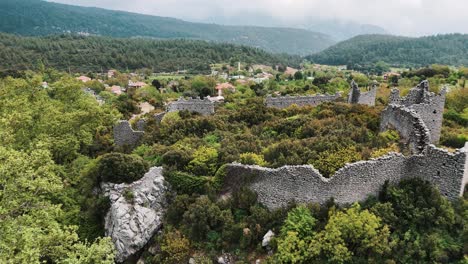 Aerial-View-of-the-Ruins-of-the-Ancient-Roman-Kadrema-Castle-Located-in-the-Gedelme-Village-and-Mountain-Ridge-on-Background