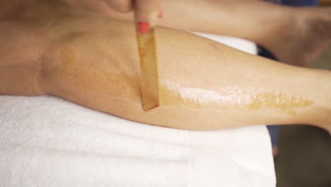 depilation procedure with wax on the legs slow motion close up