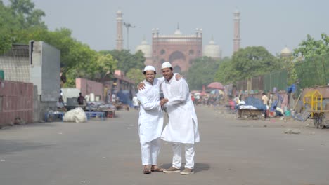 indian muslims greeting and hugging each other at a mosque