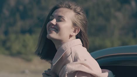 happy-nice-lady-with-short-hair-leans-out-of-driving-car