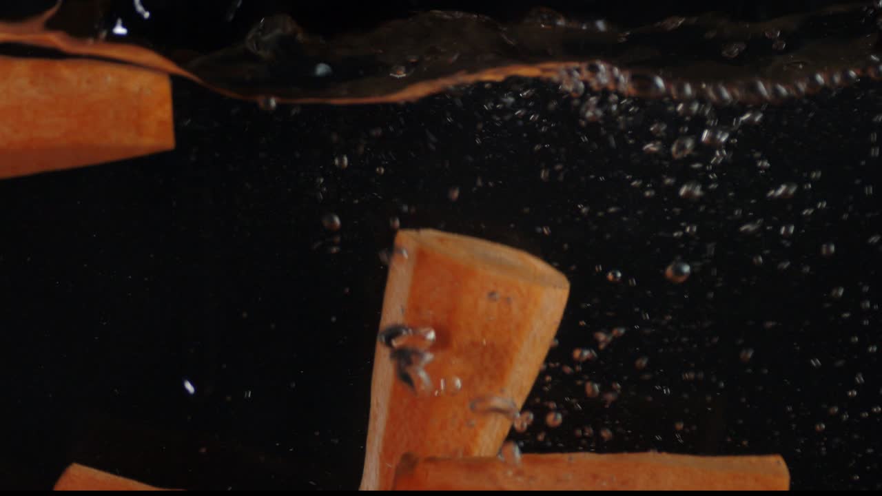 A fall of fresh carrot in water with air bubbles.