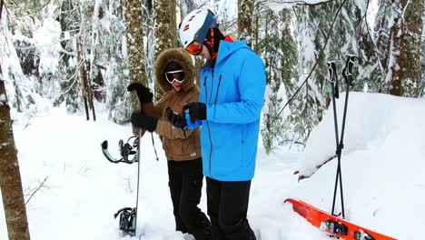 couple checking direction on compass 4k