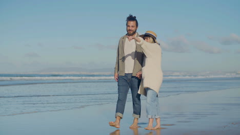 Young-Caucasian-couple-strolling-along-seashore