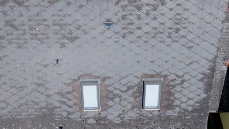 overhead view of an eternit roof tile of a house with brick chimney