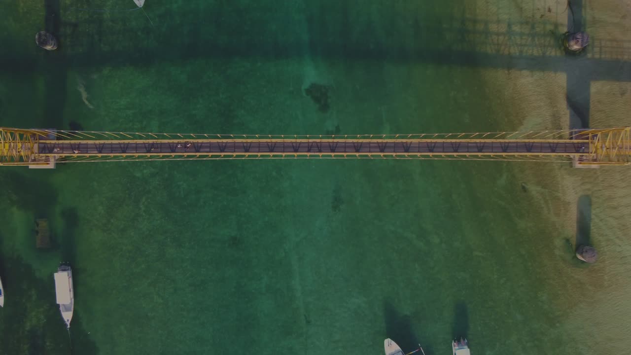 Yellow Bridge connecting Nusa Lembongan and Nusa Ceningan in Bali. Clear turquoise water and tropical island scenery