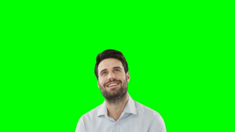 Young-man-standing-against-green-screen