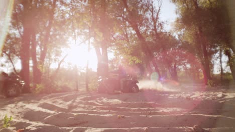 Extreme-driver-dusting-on-ATV-in-slow-motion.-Man-driving-quad-bike-on-sand